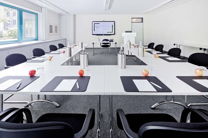 Median Hotel Hannover Lehrte Bright modern conference room with U-shaped tables and prepared workspaces