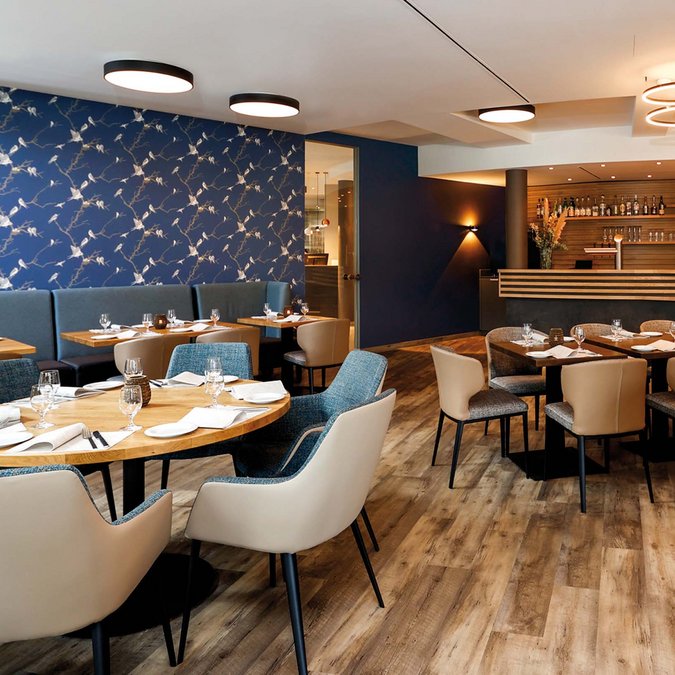 Viva – our restaurant near Hanover Modern restaurant with blue bird wallpaper and wooden flooring